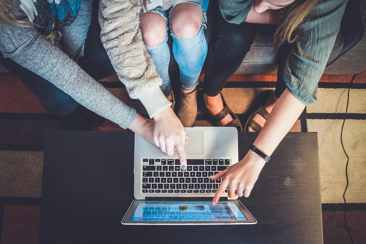 Person building a personal brand on social media with laptop and smartphone
